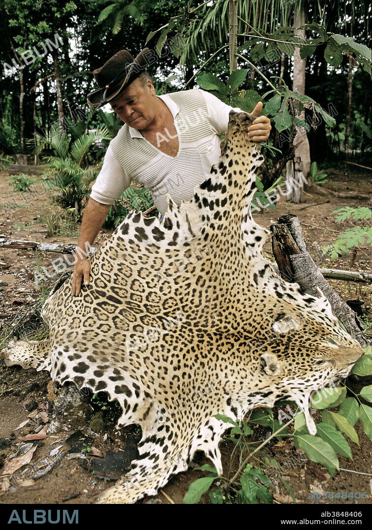 Man with jaguar skin in the Amazon rainforest.