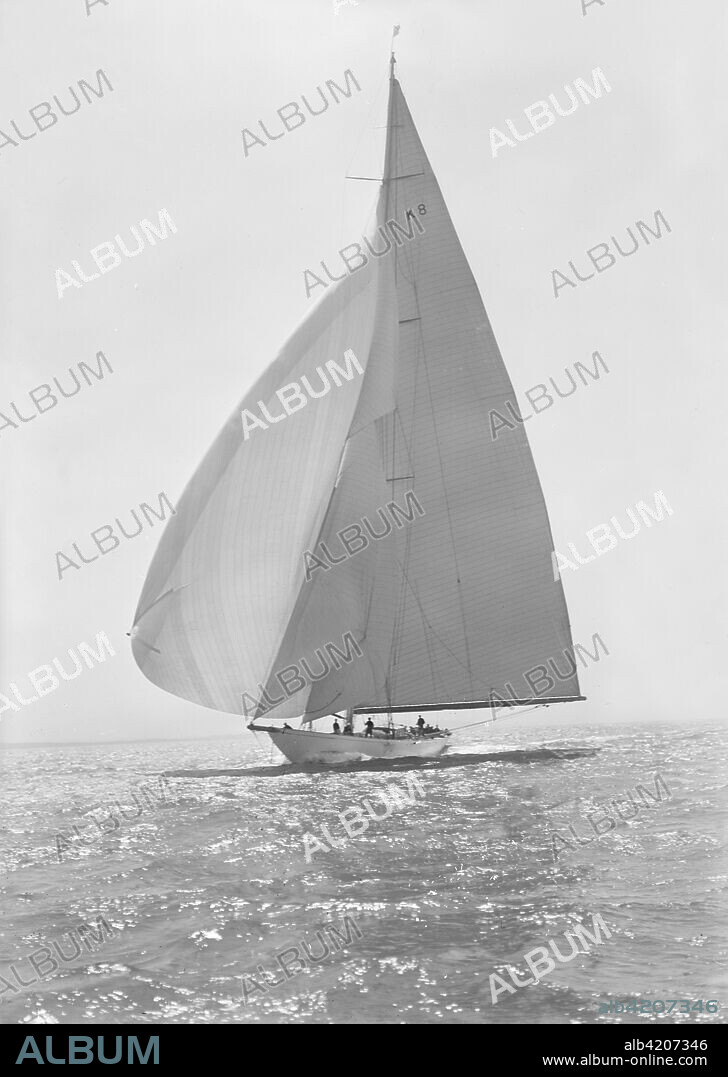 The 23 Metre 'Candida' (K8) sailing with spinnaker, 1935. 'Candida' was designed by Charles Nicholson for the banker Mr. Herman Andrae. She was launched in 1929.