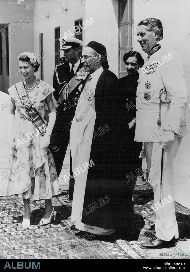 Her Majesty With The King Of Libya -- King Idris of Libya points our places of interest to the Queen and the Duke of Edinburgh form the balcony of the royal palace at Tobruk. The King later presented a number of gifts to her Majesty for members of her family. May 2, 1954. (Photo by Paul Popper, Paul Popper Ltd.).