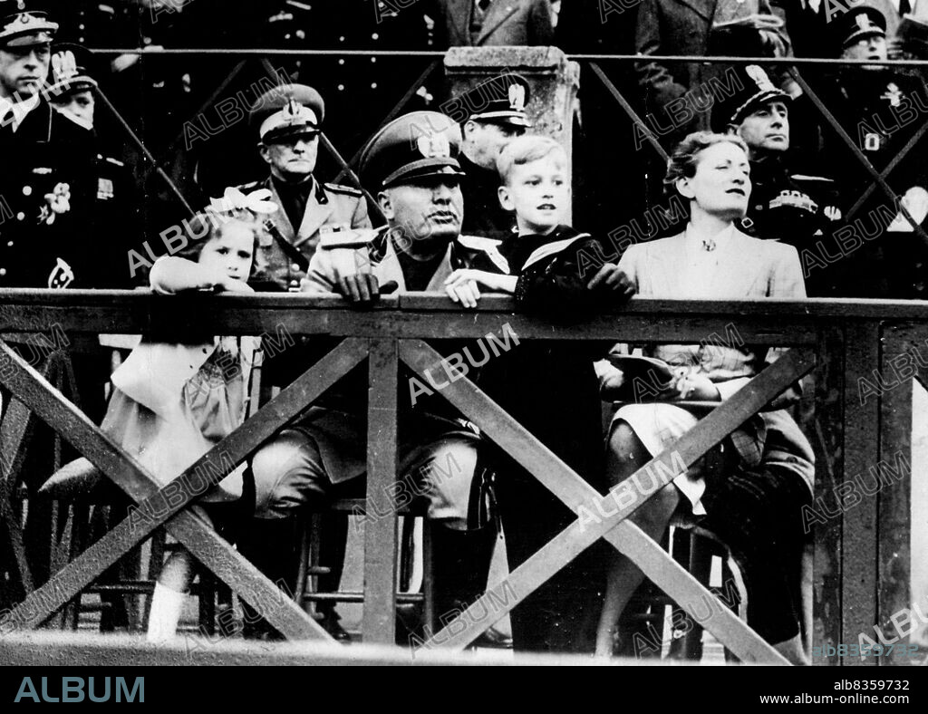 Mussolini The Family Man At Rome Horse Show - Signor Mussolini with Countess Ciano, his daughter right, and his two grandchildren, Fabrizio (the boy) and Maria, at the International Horse show in Rome on May 6.Signor Mussolini was seen in an unfamiliar guise for him at the international horse show. The duce is so often the iron dictator ***** public that it was pleasant to see ***** a family man with his daughter ***** to Count Ciano, the Italian ***** and his two grandchildren, watch ***** riding competition. May 01, 1939. (Photo by Associated Press Photo).