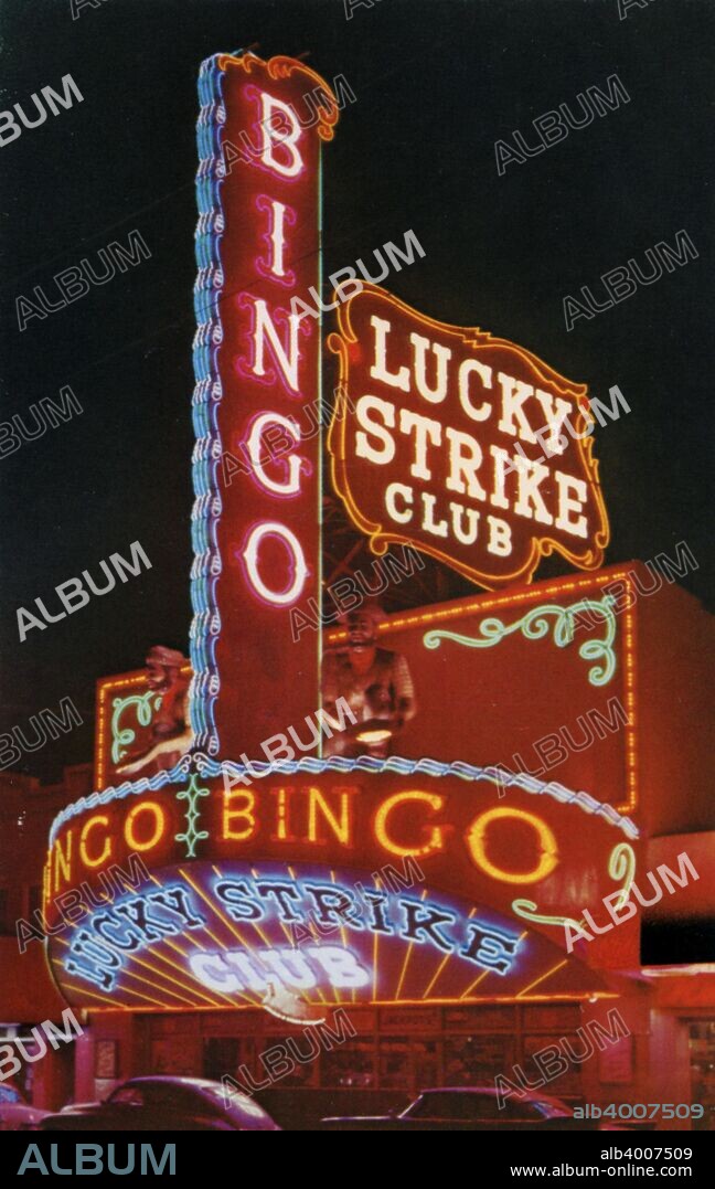 Lucky Strike Club, Las Vegas, Nevada, USA, 1956. Vintage postcard showing a night view of the entrance to the Lucky Strike Club. The casino's neon sign lights up the street.