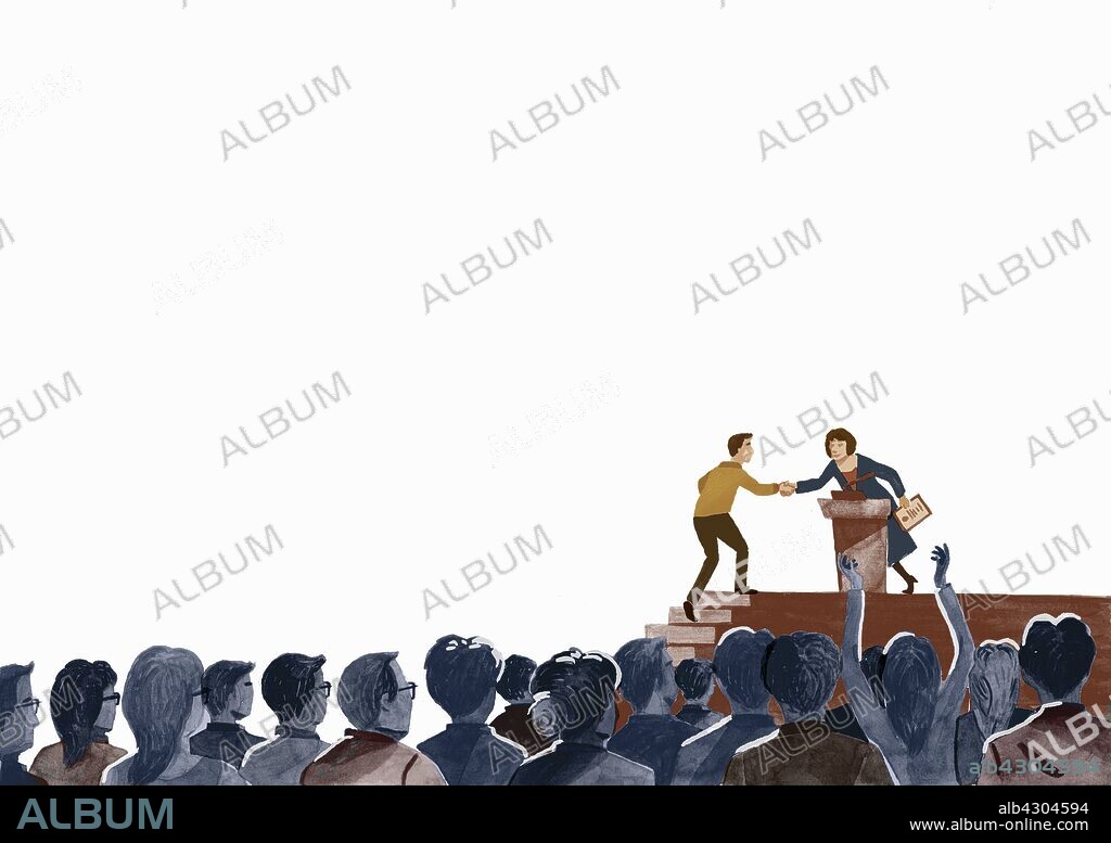 Audience applauding man receiving award on stage.
