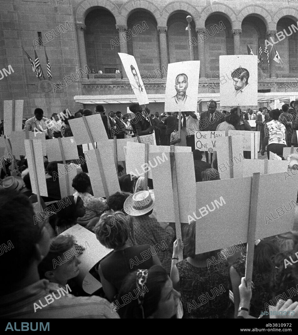 Entitled: "African-American and white Mississippi Freedom Democratic Party supporters demonstrating outside the 1964 Democratic National Convention, Atlantic City, New Jersey; some hold signs with portraits of slain civil rights workers James Earl Chaney, Andrew Goodman, and Michael Schwerner." The Mississippi Freedom Democratic Party (MFDP) was an American political party created in the state of Mississippi in 1964, during the civil rights movement. It was organized by African Americans from Mississippi, with assistance from the Student Nonviolent Coordinating Committee (SNCC) and Council of Federated Organizations (COFO), to challenge the legitimacy of the then-white-only Mississippi Democratic Party. The MFDP sent its elected delegates by bus to the Democratic National Convention in New Jersey. There they challenged the right of the Mississippi Democratic Party's delegation to participate in the convention, claiming that the regulars had been illegally elected in a completely segregated process that violated both party regulations and federal law, and that furthermore the regulars had no intention of supporting Lyndon B. Johnson, the party's presidential candidate, in the November election. They therefore asked that the MFDP delegates be seated rather than the segregationist regulars. Even though they were denied official recognition, the MFDP kept up their agitation within the Convention. Photographed by Warren K. Leffler, August, 1964.