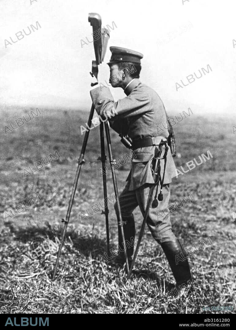 Japan: December 6, 1922 Prince Hirohito looking through the range finder at military maneuvers in Japan.