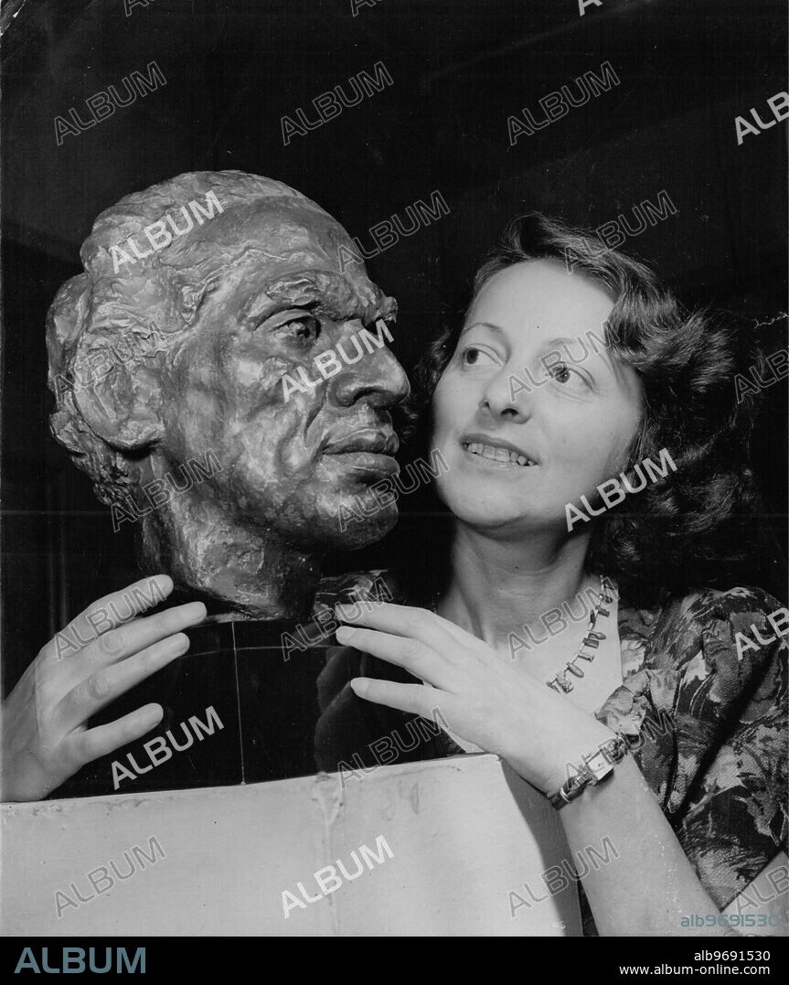 Sculptress Freda Brilliant with her bronze head of V K Krishna Menon , Indian High Commissioner in Britain at the Artists of Fame and Promise Exhibition at Leicester Galleries in London 21 August 1951.
