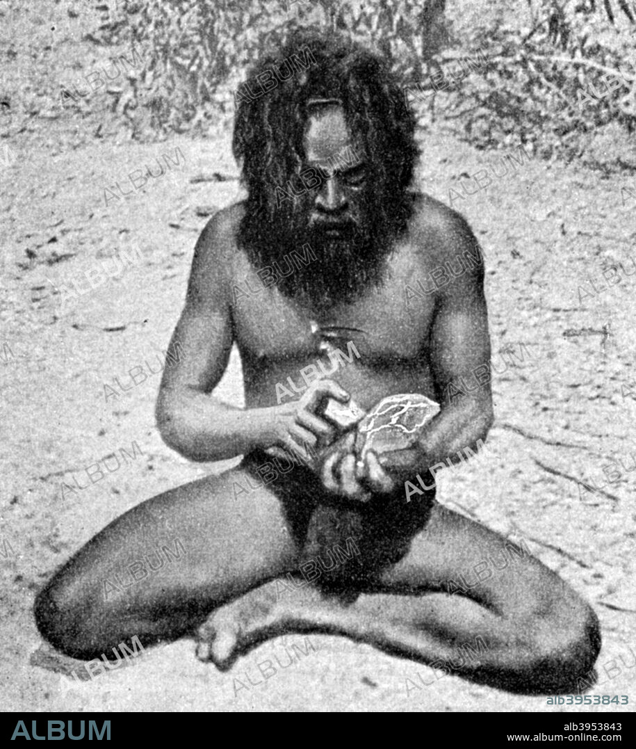 A man from the Warramunga tribe making a stone axe head, Australia, 1922. The man is chipping a block of diorite by means of a small lump of hard quartzite. From Peoples of All Nations, Their Life Today and the Story of Their Past, volume I: Abyssinia to the British Empire, edited by JA Hammerton and published by the Educational Book Company (London, 1922).