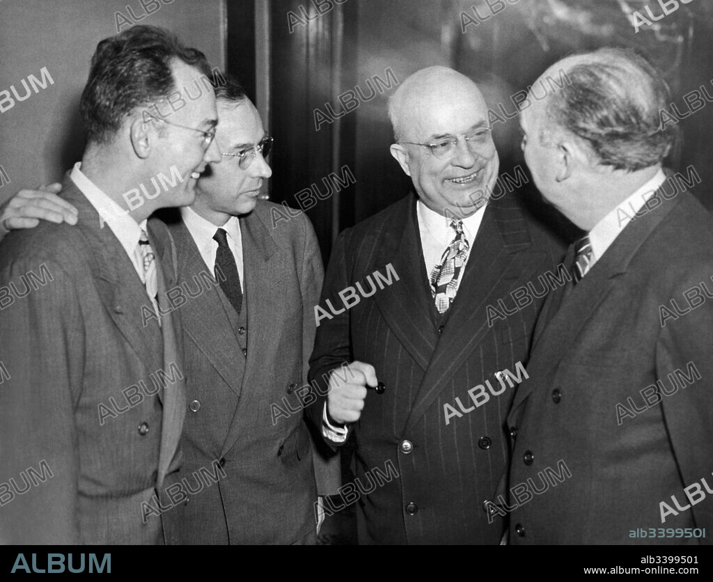 New York, New York:   January 19, 1947 Henry J. Kaiser, second from right, chairman of the Kaiser-Frazer Corporation, chats with San Francisco news reporter Robert Elliott, right, while his two sons, Henry J. Kaiser, Jr. left, and Edgar Kaiser look on. They are in town to view the premier showing of the 1947 Kaiser and Frazer automobiles at the Waldorf-Astoria.