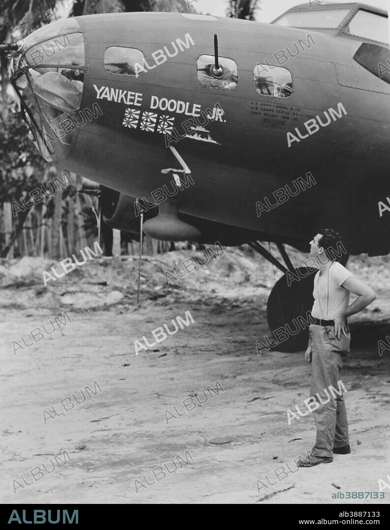 American soldier admiring the B-17 Flying Fortress nicknamed Yankee Doodle, Jr, circa 1942. The flags indicate Zeros shot down in the South Pacific combat.