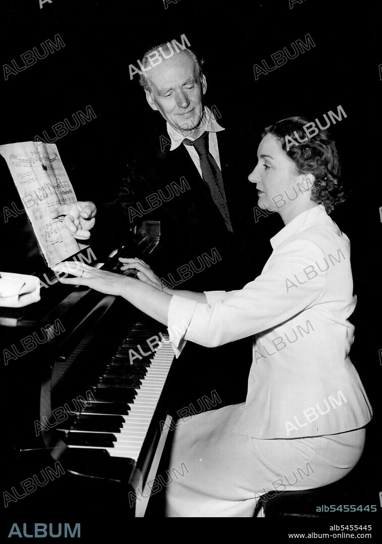 After The Wedding Came The Rehearsal -- First task after her marriage this morning to Beenet Korn, an American, was to dash off to the Albert Hall for a rehearsal in Preparation for tonight's Prom. Concert. Here is famed pianist, Moura Lympany and the Conductor, Basil Cameron. August 10, 1951.