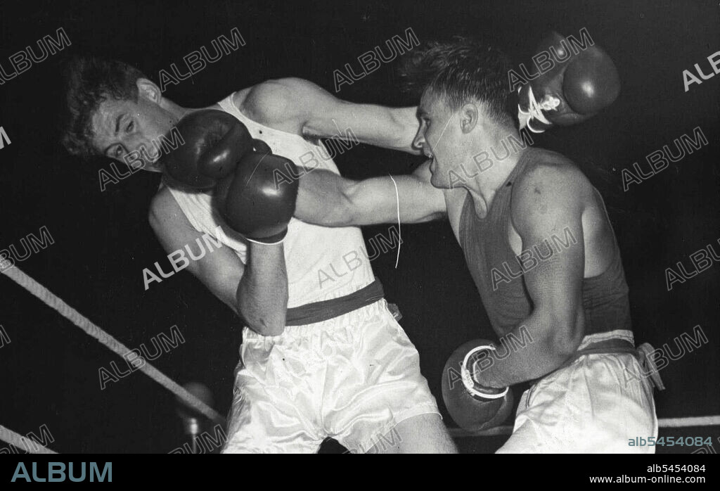 Amateur Boxing - G. Shatkov Russia - right) lands a right swing to the jaw of Bruce Wells (Gt. B.) in the middle weight bout. Wells was awarded the decision on points although the huge crowd disagreed with the verdict.Russia beats Gt. Britain. In the amateur International boxing contest held at the Wembley Arena, London, a strong Russian team defeated Gt. Britian by 8 bouts to 2. This is the first Russian team to ***** be seen in Britain since the war. October 13, 1955. (Photo by Sports & General Press Agency Ltd.).
