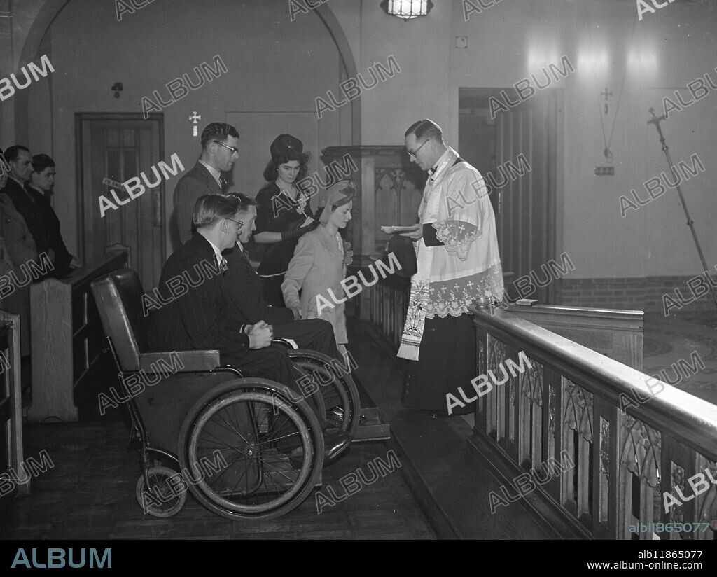 Wheel Chair Wedding. - - - - Wheel chairs were used by the guard of honour of fellow-patient when ex Coldstream Guardsmen, Sgt, George Swindlehurst, who was wounded in Germany, married Nurse Winifred Doyle at St Edwards' Roman Catholic Church, Macclesfield, Cheshire. The bride attended Sgt Swindlehurst when he was a patient at Warrington Military Hospital. - - Picture Shows: Father Coyne, conducts the ceremony uniting Sgt Swindlehurst and Miss Doyle at St Edwards. Fellow patient Bill Shiel (nearest camera) was "best man" in a wheel chair like the groom. - - - - 7th March 1948.