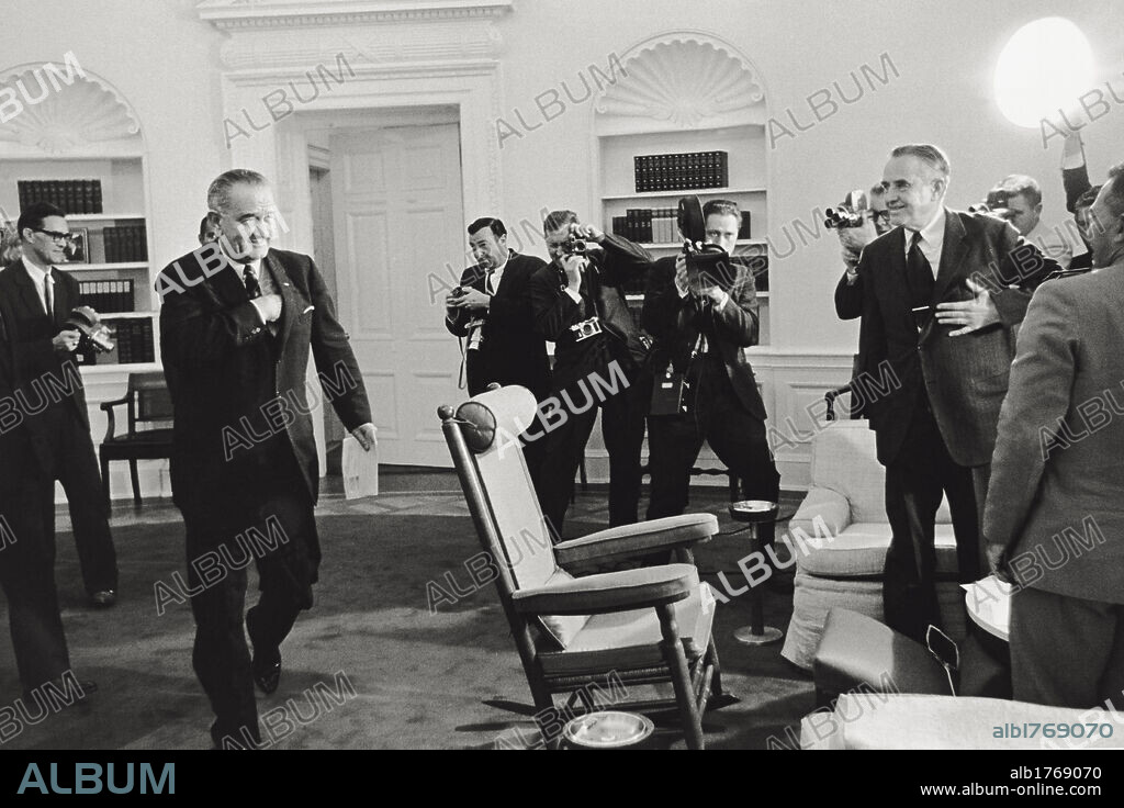 Lyndon Johnson with William Averell Harriman. The President of the United States Lyndon Johnson being surrounded by journalists and photographers during a White House meeting with Under Secretary of State William Averell Harriman. Washington, 1960s.