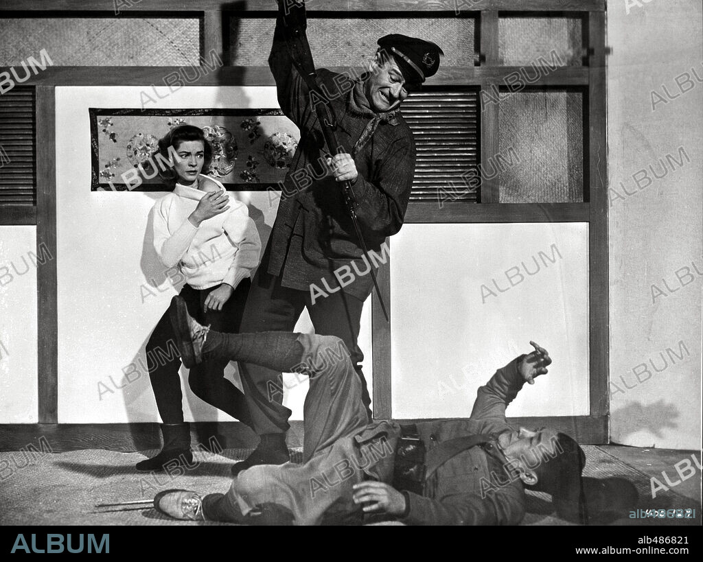 JOHN WAYNE and LAUREN BACALL in BLOOD ALLEY, 1955, directed by WILLIAM A. WELLMAN. Copyright WARNER BROTHERS.
