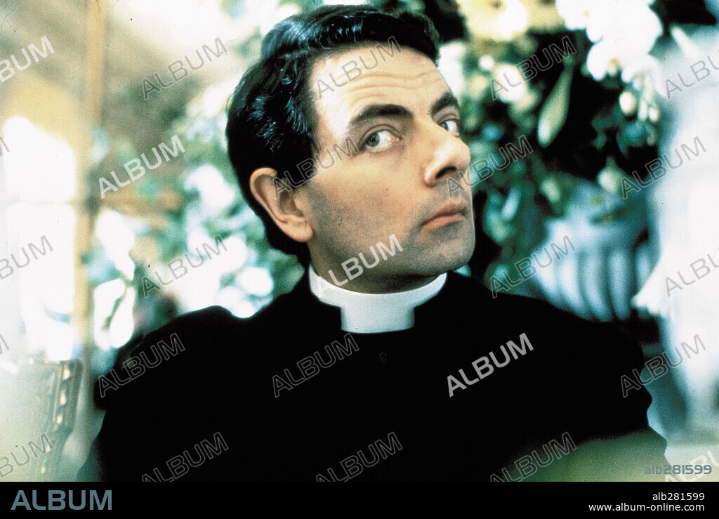 ROWAN ATKINSON in FOUR WEDDINGS AND A FUNERAL, 1994, directed by MIKE NEWELL. Copyright GRAMERCY PICTURES.