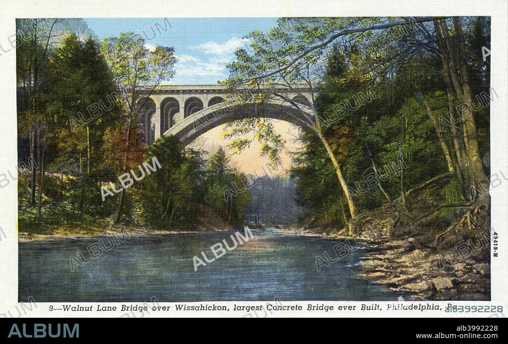 Walnut Lane Bridge over Wissahickon Creek, Philadelphia, Pennsylvania, USA, 1914. Vintage postcard showing a view down the Wissahickon Creek and under the Walnut Lane Bridge. There are wooded areas on both sides of the creek. Designed by George S Webster of the Philadelphia Department of Public Works, the bridge was built between 1906 and 1908. At the time of its completion it was the longest and highest concrete arch bridge in the world.
