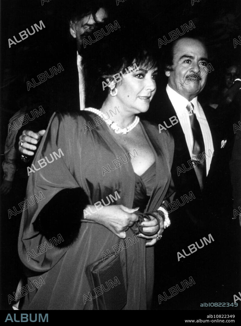 ADNAN KHASHOGGI (25 July 1935 - 6 June 2017) the flamboyant Saudi arms trader who rose to spectacular wealth in the 1970s and 1980s while treating the world to displays of decadence breathtaking even by the standards of that era, died on Tuesday in London. He was 81. PICTURED: ELIZABETH TAYLOR and ADNAN KHASHOGGI in 1989. (Credit Image: © Globe Photos/ZUMA Wire).