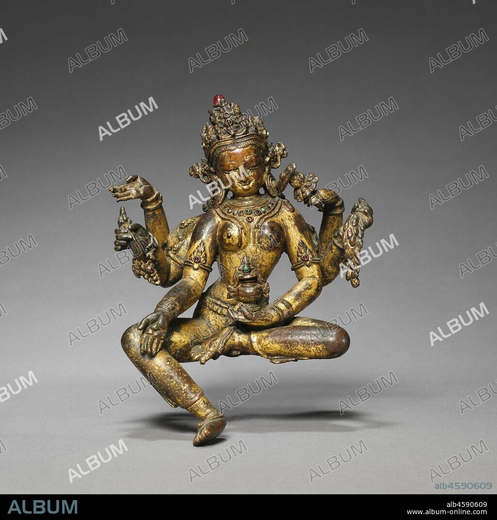 Vasudhara, Goddess of Abundance, 1300s-1400s. In Nepal this female counterpart of the god of wealth is one of the most popular divinities. This image was set up in either a domestic shrine or a Buddhist monastery, where devotees would pray to her for wealth, prosperity, and children. In each of her six arms she holds objects pertaining to life and abundance: jewels, an overflowing pot, and a sheaf of wheat. A Buddhist philosophical text rests on top of the lotus flower she holds in her topmost left hand, suggesting that wealth and prosperity can derive from the acquisition of true knowledge.