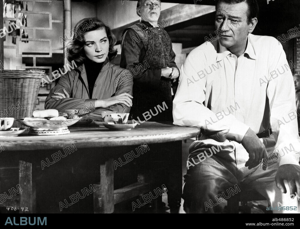 JOHN WAYNE and LAUREN BACALL in BLOOD ALLEY, 1955, directed by WILLIAM A. WELLMAN. Copyright WARNER BROTHERS.