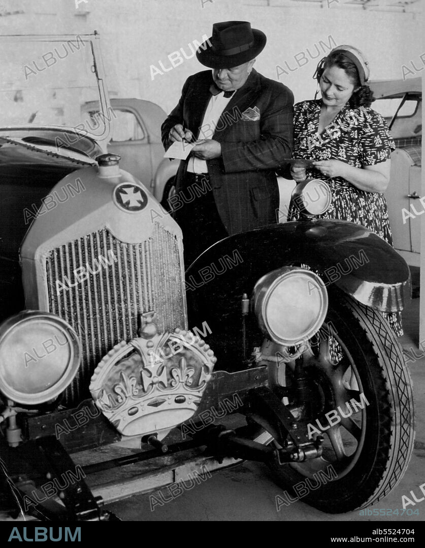 Mr. & Mrs. Sydney Dawson of Manly make an offer for the 1918 Crosley car used by Duke of Windsor during 1920 tour of sale is highest ***** Tenders during XMAS car proceeds in aid of NSW ***** for Crippled children. December 20, 1954. (Photo by Ross/Fairfax Media).