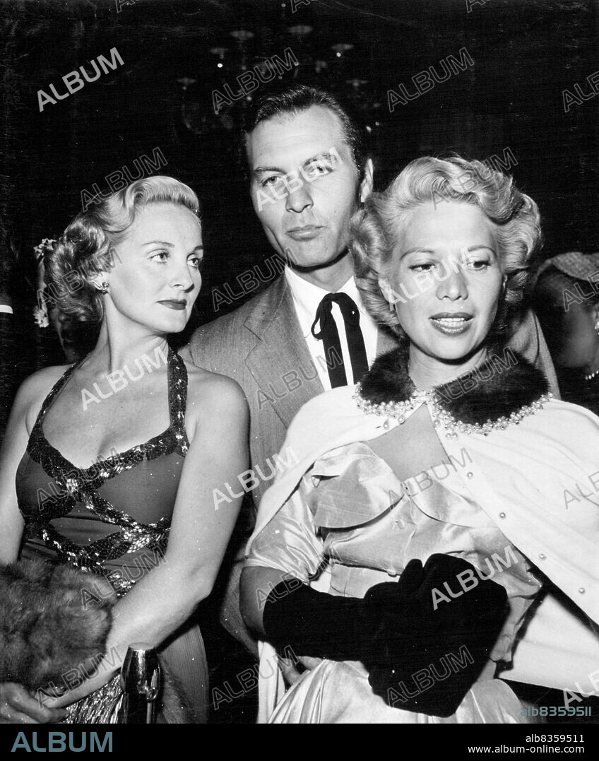 Dinah Shore and husband George Montgomery with one-time star Constance Moore. Dinah caused quite a stir with her cardigan-type jacket with its mink and pearl collar. December 2, 1952.