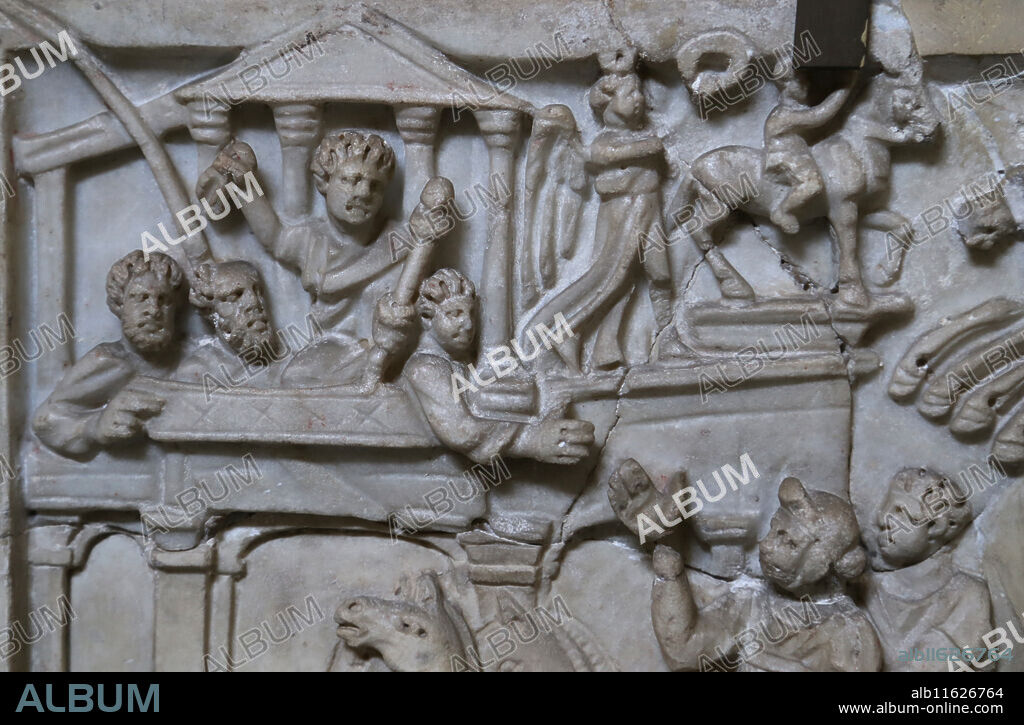 Relief. Chariot race in the Circus Maximus, Rome, 3rd c. AD. Left side; closer view showing the imperial enclosure (pulvinar) with the emperor holding what appears to be the mappa in his right hand. On the side of the pulvinar are two statues of deities, Victoria and one of the Dioscuri. Rome, Vatican Museum (Chiaramonti).