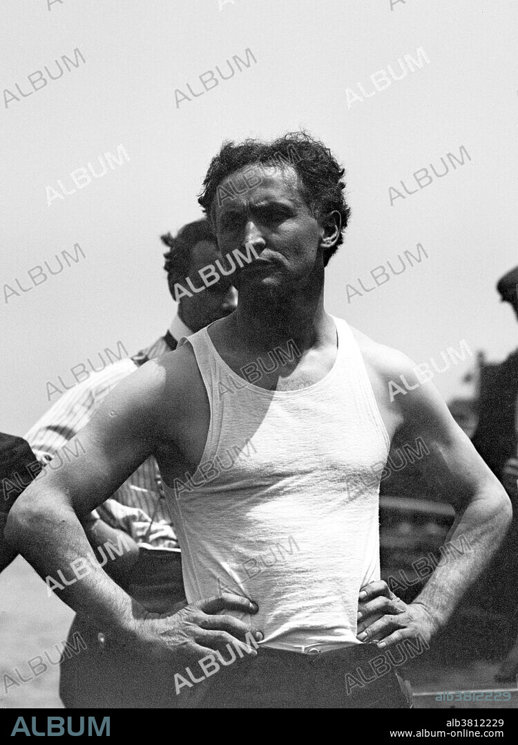Entitled: "Houdini" photographed by the Bains News Service, circa 1910-15. Harry Houdini (March 24, 1874 - October 31, 1926) was a Hungarian-American illusionist and stunt performer, noted for his sensational escape acts. He began his magic career in 1891. He focused initially on traditional card tricks and billed himself as the "King of Cards". He soon began experimenting with escape acts. He first attracted notice as "Harry Handcuff Houdini" on a tour of Europe, where he challenged police forces to keep him locked up. Soon he extended his repertoire to include chains, ropes slung from skyscrapers, straitjackets under water, and having to hold his breath inside a sealed milk can. He concealed the exact details of his escapes to maintain an air of mystery and suspense. As President of the Society of American Magicians, he was keen to uphold professional standards and expose fraudulent artists. He was also quick to sue anyone who pirated his escape stunts. Houdini died of peritonitis, secondary to a ruptured appendix at the age of 52.