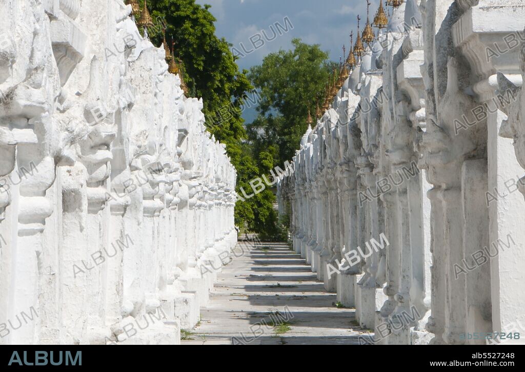 The entire Tipitaka Pali canon of Theravada Buddhism is set on 729 marble slabs, each with 80 to 100 lines of text, originally in gold ink, on both the obverse and the reverse sides. Each stone is three and a half feet wide, five feet tall and five inches thick and housed in a <i>kyauksa gu</i> or a small cave-like stupa. Kuthodaw Pagoda, literally meaning Royal Merit Pagoda, and formally titled Mahalawka Marazein, is a Buddhist temple and stupa located in Mandalay, central Burma. It lies at the foot of Mandalay Hill and was built during the reign of King Mindon (1808—78). The stupa itself, which is gilded above its terraces, is 57 m (188 ft) high, and is modelled after the Shwezigon Pagoda at Nyaung-U near Bagan. In the grounds of the pagoda are 729 'kyauksa gu' or stone-inscription caves, each containing a marble slab inscribed on both sides with a page of text from the Tipitaka, the entire Pali Canon of Theravada Buddhism. The stone inscriptions are considered to be the largest book in the world. Mandalay, a sprawling city of more than 1 million people, was founded in 1857 by King Mindon to coincide with an ancient Buddhist prophecy. It was believed that Gautama Buddha visited the sacred mount of Mandalay Hill with his disciple Ananda, and proclaimed that on the 2,400th anniversary of his death, a metropolis of Buddhist teaching would be founded at the foot of the hill.