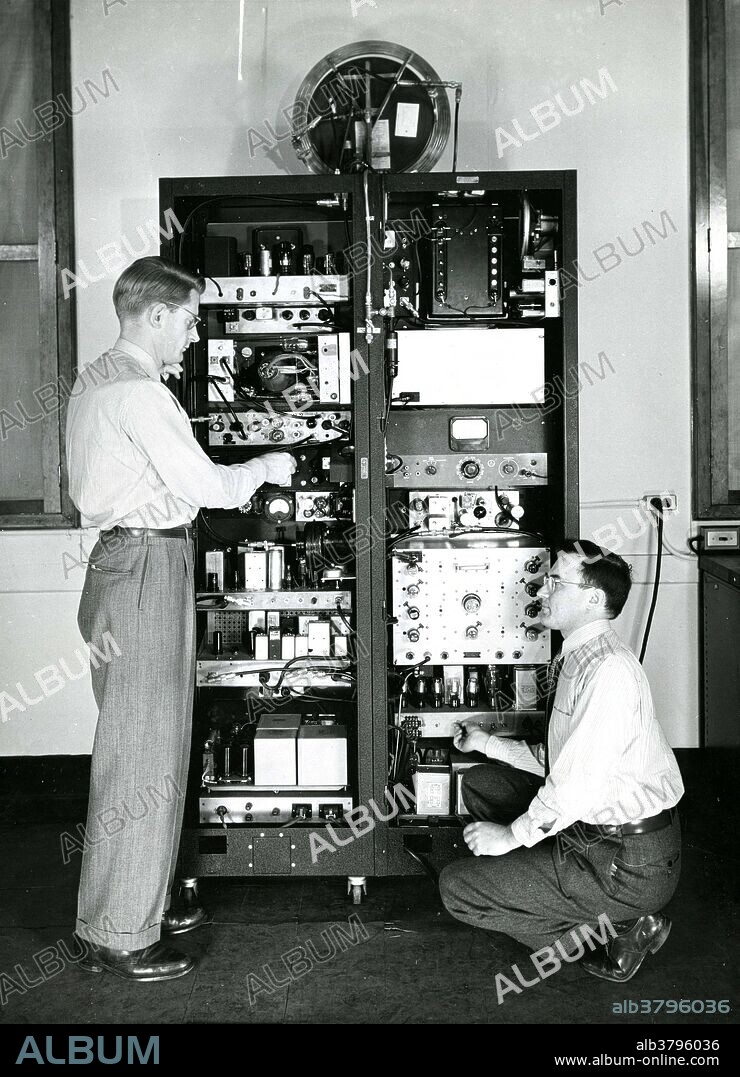 Back side of ammonia molecule clock with B. F. Husten and E. D. Heberling. An atomic clock is a clock device that uses an electronic transition frequency in the microwave, optical, or ultraviolet region of the electromagnetic spectrum of atoms as a frequency standard for its timekeeping element. The principle of operation of an atomic clock is not based on nuclear physics, but rather on atomic physics; it uses the microwave signal that electrons in atoms emit when they change energy levels. The idea of using atomic transitions to measure time was first suggested by Lord Kelvin in 1879. Magnetic resonance, developed in the 1930s by Isidor Rabi, became the practical method for doing this. In 1945, Rabi first publicly suggested that atomic beam magnetic resonance might be used as the basis of a clock. The first atomic clock was an ammonia maser (microwave amplification by stimulated emission of radiation) device built in 1949 at the U.S. National Bureau of Standards (NBS, now NIST). The world's first atomic clock using the ammonia molecule as the source of vibrations.