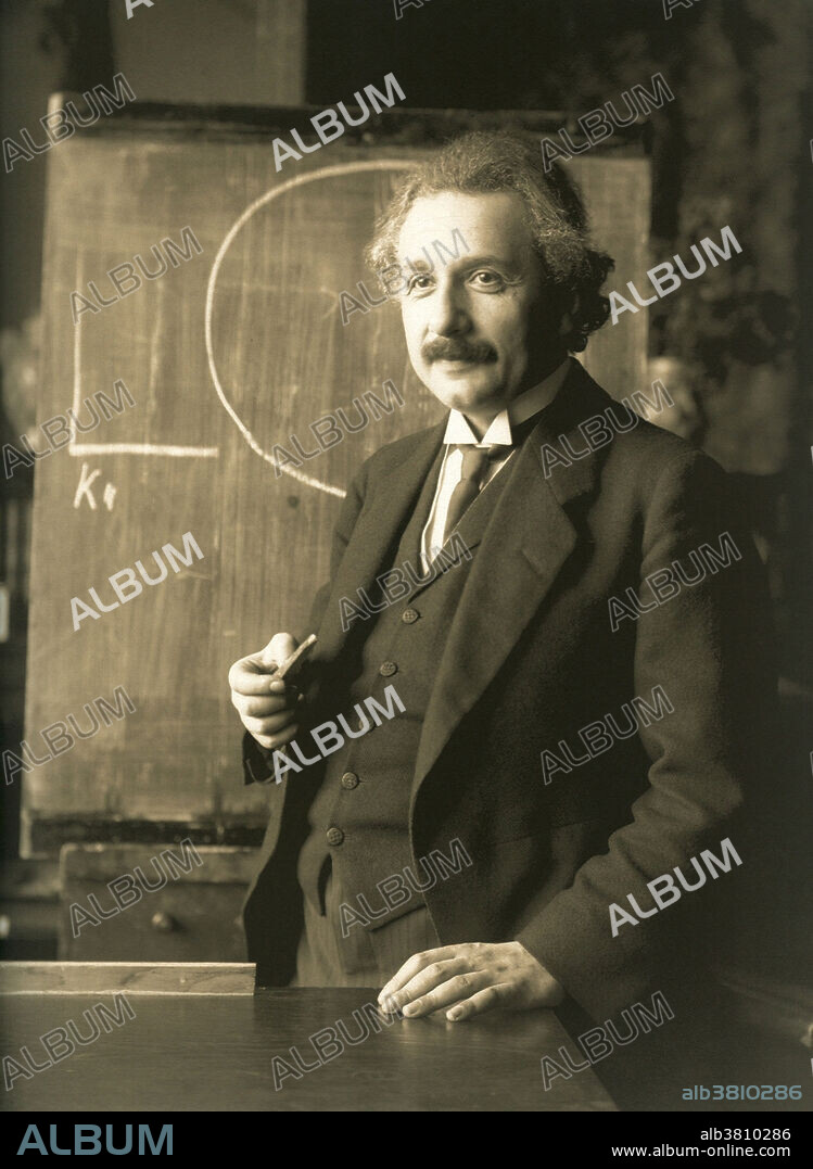 Editorial use only . Albert Einstein during a lecture in Vienna in 1921. Photographed by Ferdinand Schmutzer (1870-1928). Albert Einstein (March 14, 1879 - April 18, 1955) was a German-born theoretical physicist who developed the general theory of relativity, effecting a revolution in physics. Einstein is often regarded as the father of modern physics and the most influential physicist of the 20th century. While best known for his mass-energy equivalence formula E = mc2, he received the 1921 Nobel Prize in Physics for his services to theoretical physics, and especially for his discovery of the law of the photoelectric effect. The latter was pivotal in establishing quantum theory within physics.