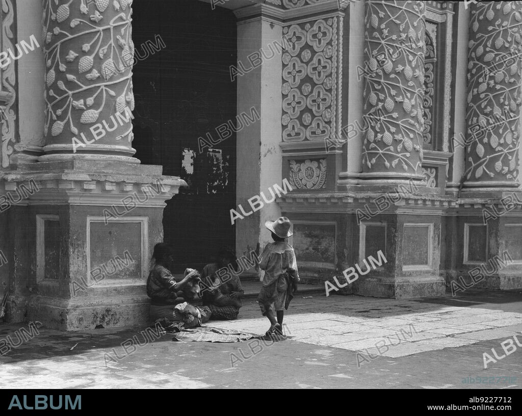 ARNOLD GENTHE. Travel views of Cuba and Guatemala, between 1899 and 1926. Women and children outside a church with ornate plasterwork decoration.