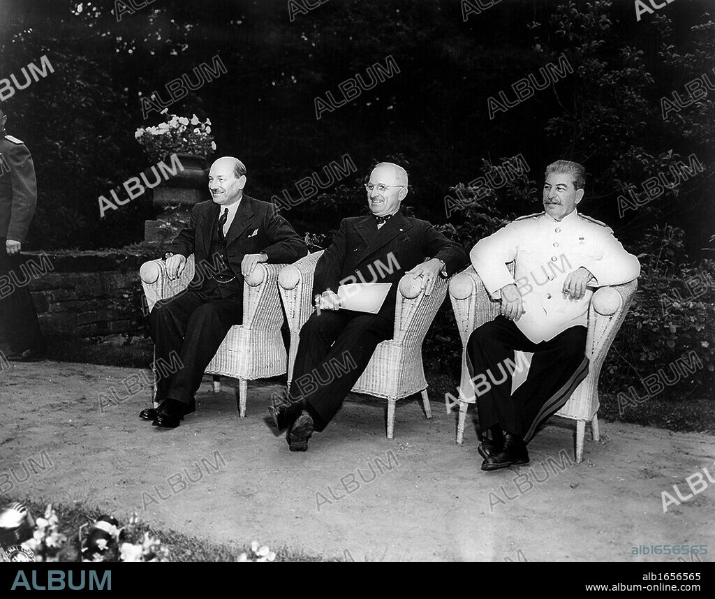 Clement Attlee, Harry Truman, and Joseph Stalin, seated outdoors at the Potsdam (Berlin) conference in 1945.