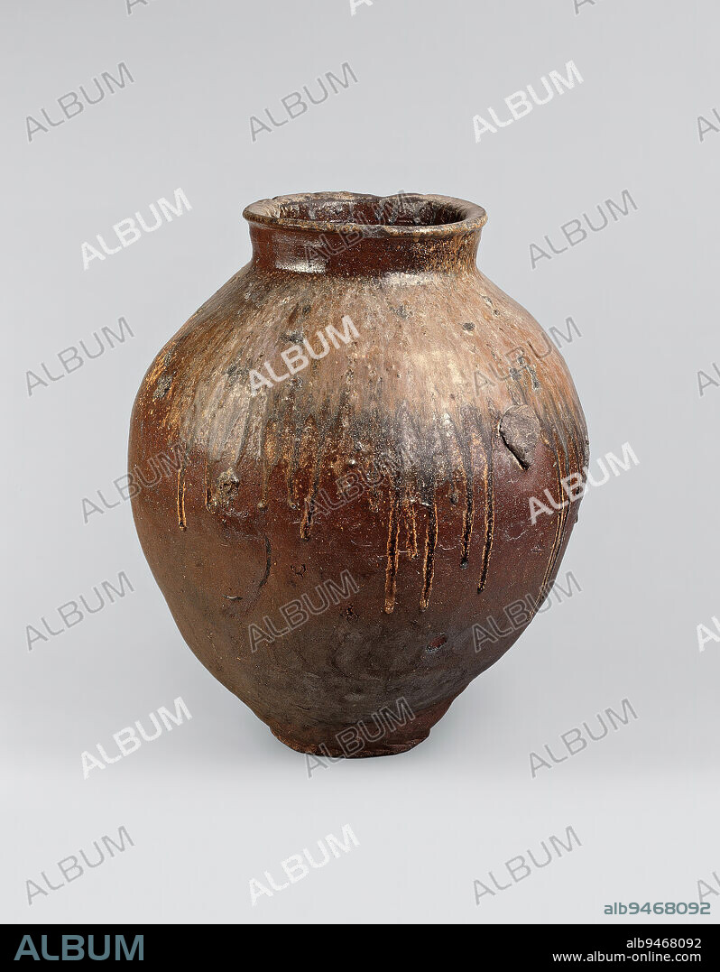 Storage jar, early 17th century, Unknown Japanese, 21 1/2 × 17 1/2 × 18 in. (54.61 × 44.45 × 45.72 cm), Tokoname ware; stoneware with natural ash glaze, Japan, 17th century, A light-colored glaze descends from the wide neck and covers the sloping shoulders of this storage jar from the Tokoname kilns. Named for the town of Tokoname on the Chita Peninsula south of Nagoya, Tokoname ware has been produced since the eleventh century at a number of kilns in the vicinity of the town. The high iron content of Tokoname clay leads to a characteristic dark, red-brown surface.