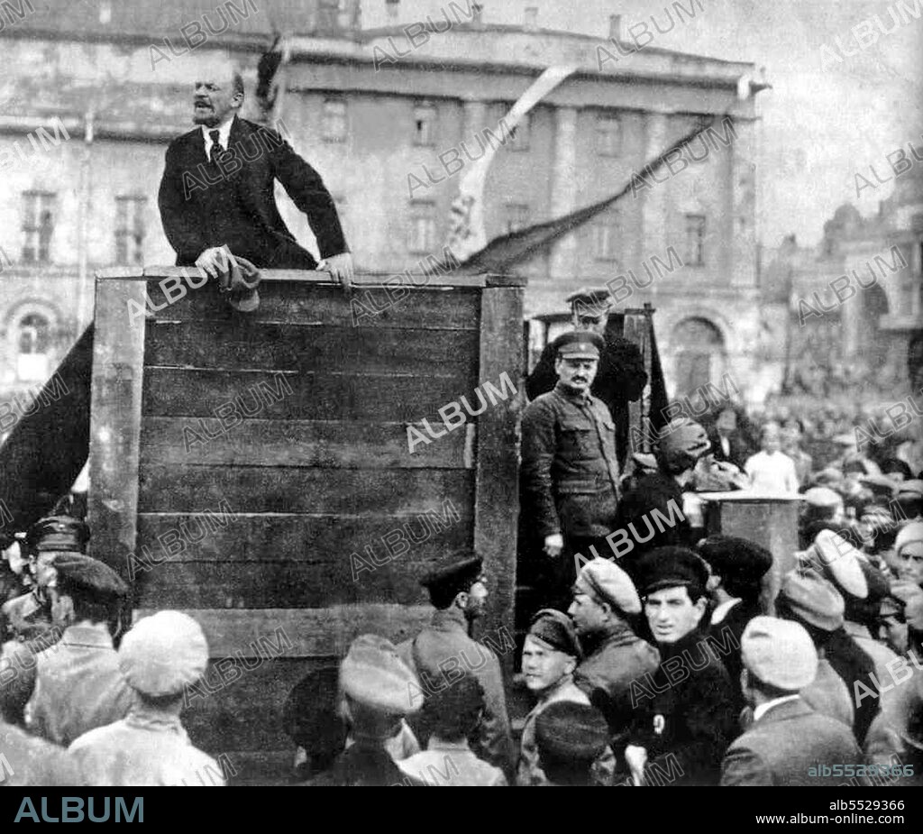 Lenin speaking at an assemble of Red Army troops bound for the Polish front. Photograph taken in Sverdlov Square, Moscow, on 5 May 1920. This is the original image with Trotsky and Kamenev standing on the steps of the platform; later versions produced under Stalin's administration had them removed.