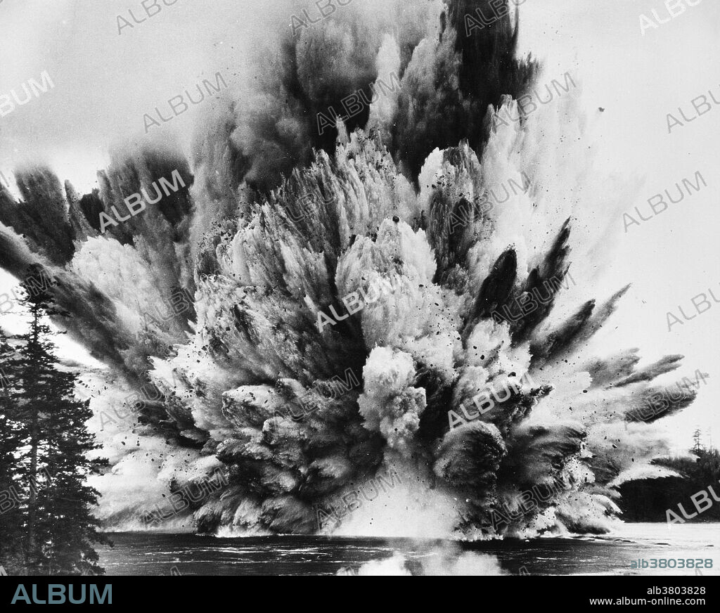 Ripple Rock explosion in Seymour Narrows, British Columbia, 1958.This was the largest non-atomic blast ever set off at the time. It ripped out two great mountain peaks, long a peril to ships in the inland passage to Alaska. Some 2,750,000 pounds of 'Nitramex' 2H blasting agent supplied by Du Pont of Canada lifted 700,000 tons of water and rock, and ripped asunder Ripple Rock, the underwater mountain.