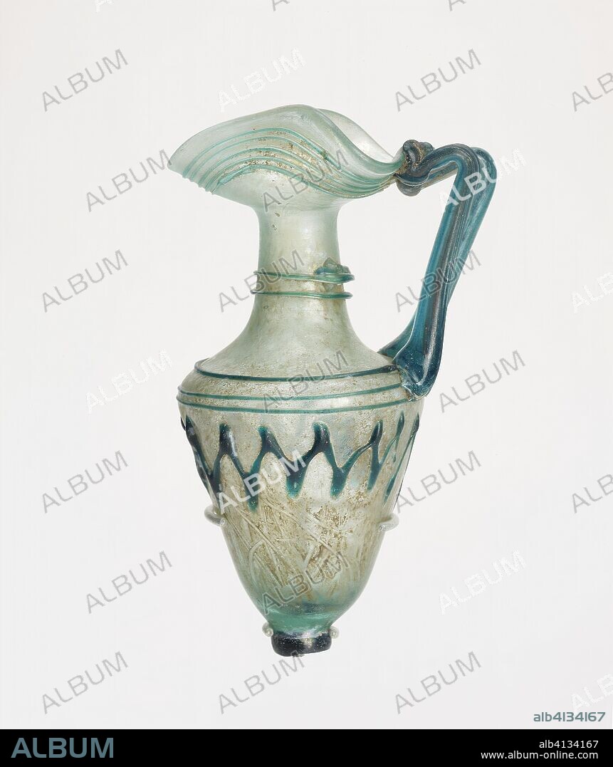 ANCIENT ROMAN. Jug. Late Roman or Byzantine; Eastern Mediterranean. Date: 301 AD-400 AD. Dimensions: 12.3 × 7.2 × 5.6 cm (4 7/8 × 2 7/8 × 2 1/4 in.). Glass, blown technique. Origin: Levant.