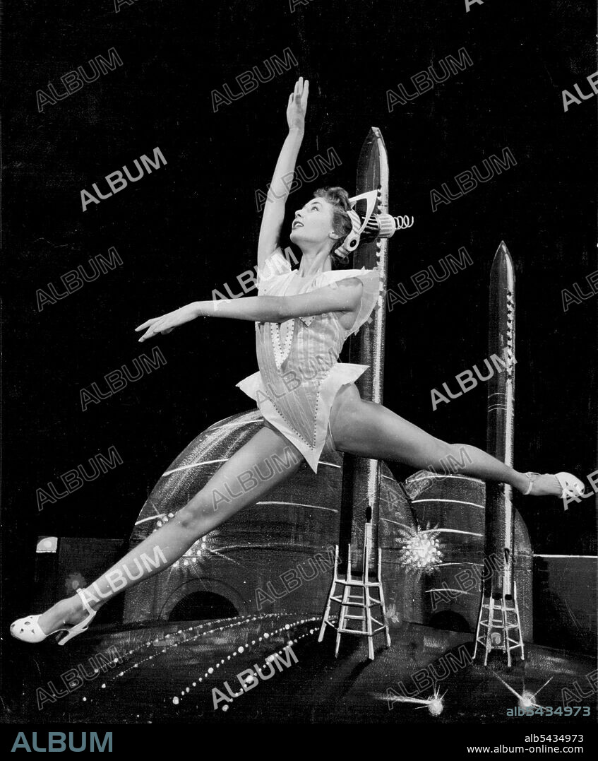 Rocket Girl -- Vivacious Windmill Girl Margot Holden would be a welcome addition to anyone's Guy Fawkes night entertainment. Actually this scene from the Windmill Theatre's 'Revudeville' is concerned with bigger rockets than those fired on November 5th. It is a modernistic number called 'Trio From Space." Margot has just rejoined the company at the famous London theatre after a ten-week honeymoon. November 02, 1955. (Photo by Reuterphoto).