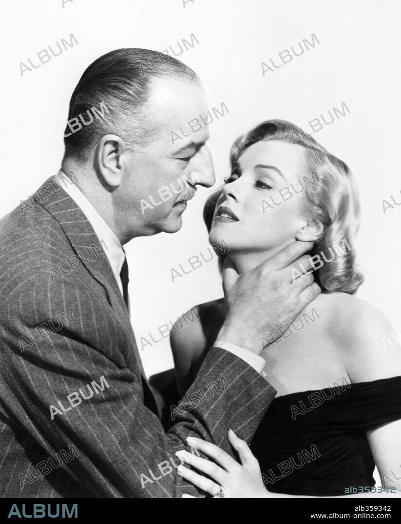 NORMA JEAN BAKER and LOUIS CALHERN. LOUIS CALHERN and MARILYN MONROE in THE ASPHALT JUNGLE, 1950, directed by JOHN HUSTON. Copyright M.G.M.