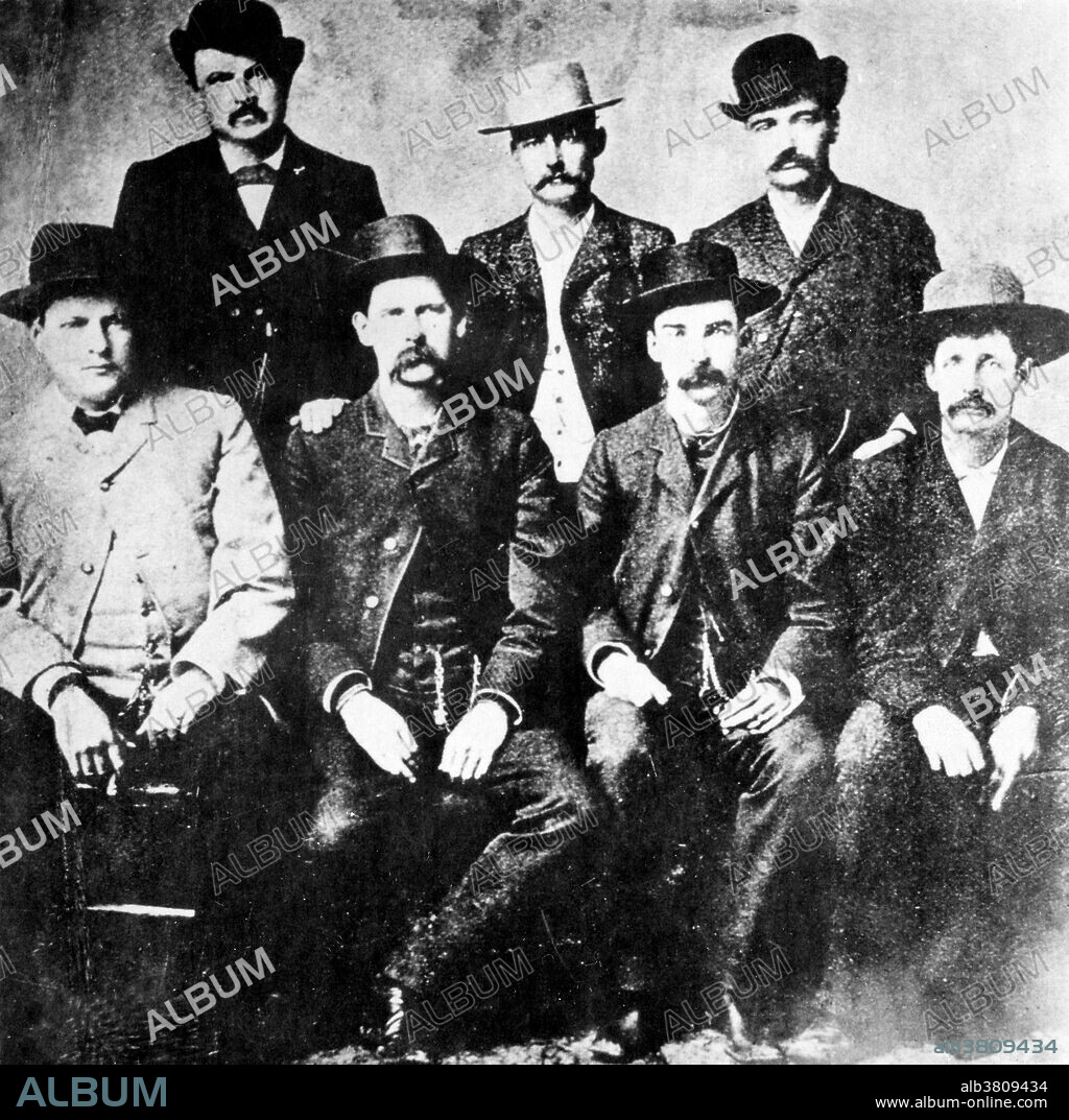 The Dodge City Peace Commission, June 1883. From left to right, standing: W.H. Harris, Luke Short, Bat Masterson, W.F. Petillon. Seated: Charlie Bassett, Wyatt Earp, Frank McLain and Neal Brown. The Dodge City War was a bloodless conflict that took place in 1883 in Dodge City, Kansas. It came at the close of the first ten years of the city's history at a time when the cattle drive and saloons were fading as a dominant force in the city's politics. From its founding, Dodge had a reputation for corruption and was often called "the Wickedest City in America." The informal association known as the Dodge City Gang dominated the law enforcement and much of the political life of the community, and monopolized the whiskey trade. In 1879 the anti-gang faction won a closely fought election for Ford County, defeating popular gang member Bat Masterson. This was the first in a number of elections that ousted the members of the gang from positions of power.