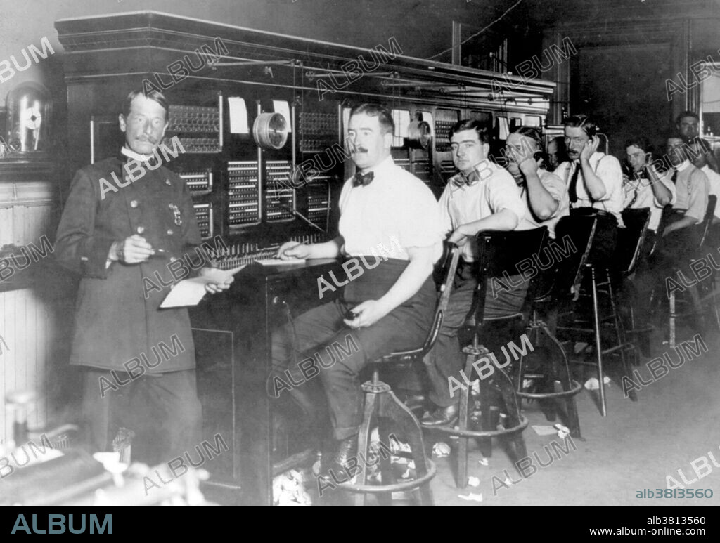 NYC Police Department telephone operators lined up at police headquarters switchboard, 1909. In the early days of telephony companies used manual telephone switchboards, and switchboard operators connected calls by inserting a pair of phone plugs into the appropriate jacks. Each pair of plugs was part of a cord circuit with a switch associated that let the operator participate in the call. Each jack had a light above it that lit when the telephone receiver was lifted. Lines from the central office were usually arranged along the bottom row. Before the advent of automatic exchanges, an operator's assistance was required for anything other than calling telephones across a shared party line. Callers spoke to an operator at a Central Office who then connected a cord to the proper circuit in order to complete the call. Automatic, or Dial systems were developed in the 1920s to reduce labor costs as usage increased, and to ensure privacy to the customer. Companies observed that women were generally more courteous to callers. However, a contributing factor to women entering this workforce was because women were paid from one half to one quarter of a man's salary. Photographed by Bain News Service, 1909.