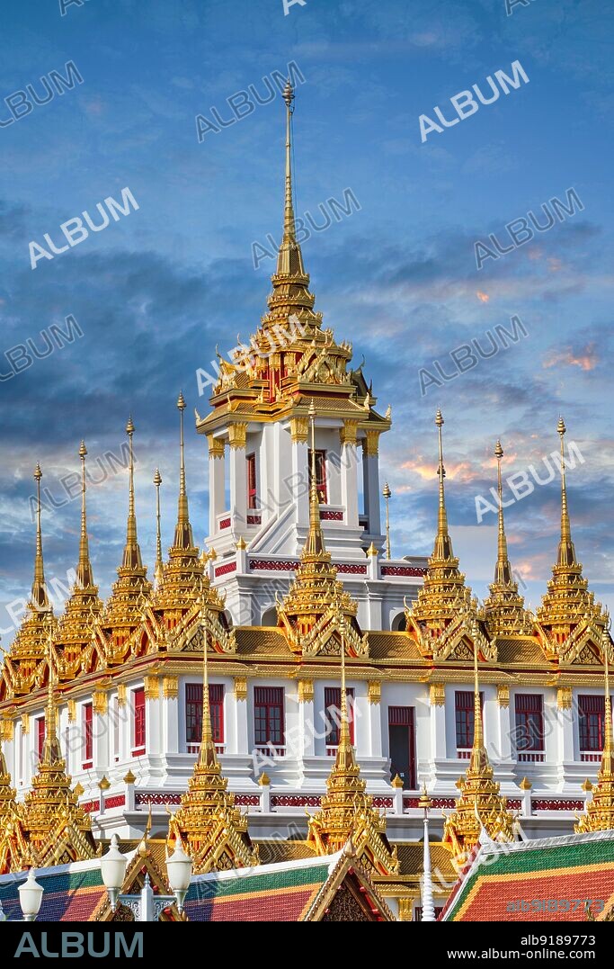 Thailand: The Loha Prasad building (Brazen Palace or Iron Monastery), modelled on an ancient Buddhist monastery in Sri Lanka, in the grounds of Wat Ratchanatda, Bangkok. Wat Ratchanatda (Wat Ratchanaddaram) was built on the orders of King Nangklao (Rama III) for Mom Chao Ying Sommanus Wattanavadi in 1846. The temple is best known for the Loha Prasada (Loha Prasat), a multi-tiered structure 36 m high and having 37 metal spires.. Thailand: The upper section of the splendid, gilded Lohaprasad ('Iron Palace') in the grounds of Wat Ratchanadta in the old city center (Rattanakosin Island) of Bangkok. The LohaprasadÄôs architecture was inspired by an old Buddhist monastery in Ceylon (now Sri Lanka).