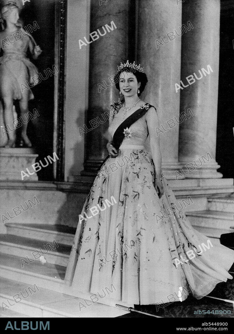 Royal Command Portrait By Baron: H.M. Queen Elizabeth II Queen Elizabeth is seen in a yellow tulle evening gown decorated with sprays of mimosa and gold paillette embroidery; she is wearing the blue Ribbon and star of the Garter. These are some details of her Majesty's Diamond shown in the Portrait: The neck lack is a wedding present from the Nizam of Hyderabad; the tiara, also a wedding present, from the late Queen Mary. The bow brooch, drop earrings, bracelet and platinum wrist watch are also set in diamonds. December 14, 1953. (Photo by Associated Press Photo).