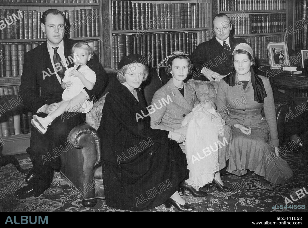 Emma Mary And Godparents After The Christening Today -- Left of right, Capt. Christopher Soames holding his son, Nicholas; Mrs. Duncan Sandys, daughter of Winston Churchill; Lady Rupert Nevill, godmother of the baby, Emma Mary Somes whom she is holding; M. Andre de Staree, godfather of the child; and Mrs. Christopher Soames, the child mother, at the Christening reception today in the home of Capt. G. Soames, at Sheffield Park, Fletching, Sussex. Mr. Winston Churchill and Mrs. Churchill attended the christening of a grandchild today (Sunday) in the 13th century church at Fletching, Sussex. November 6, 1949. (Photo by Reuterphoto).