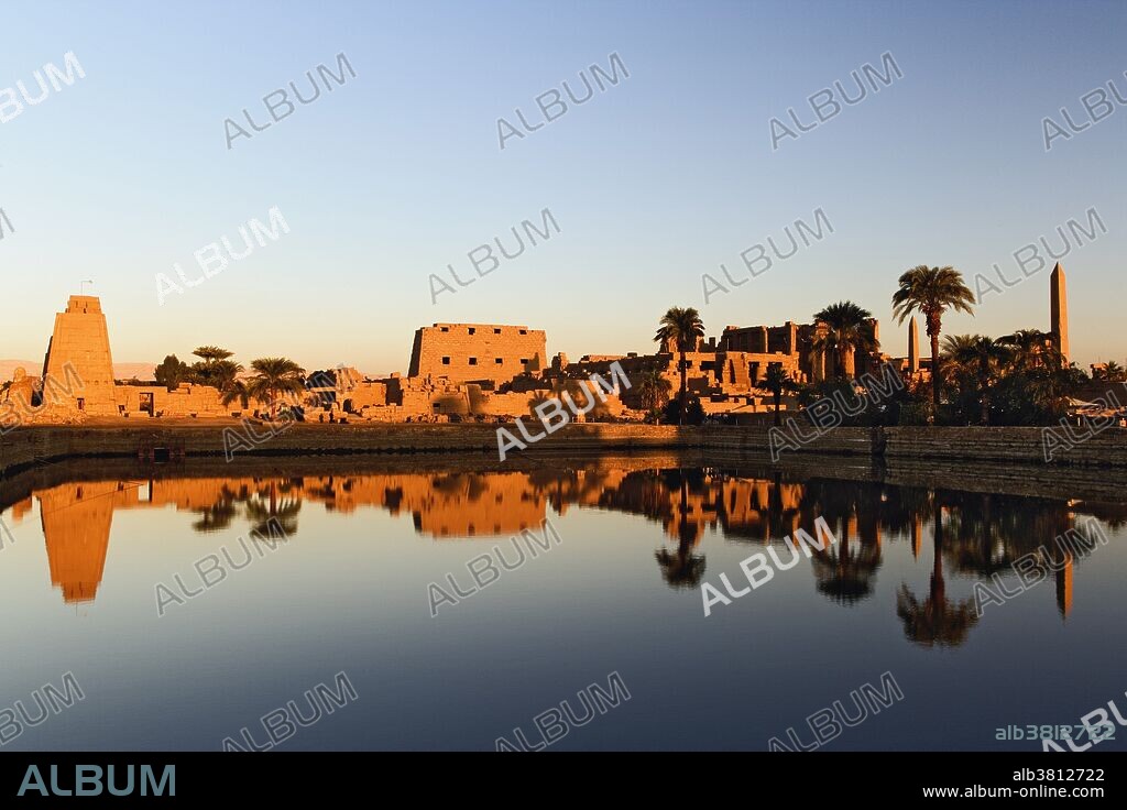 The Precinct of Amun-Re, part of the Karnak Temple Complex, at sunrise. Karnak was the residence of gods, Amun-Re, his wife Mut, and their son Khonsu, the moon god. The complex lies 4 kilometers to the north of modern day Luxor, or ancient Thebes. Built in the 12th dynasty, 2000 B.C.- 220 B.C.
