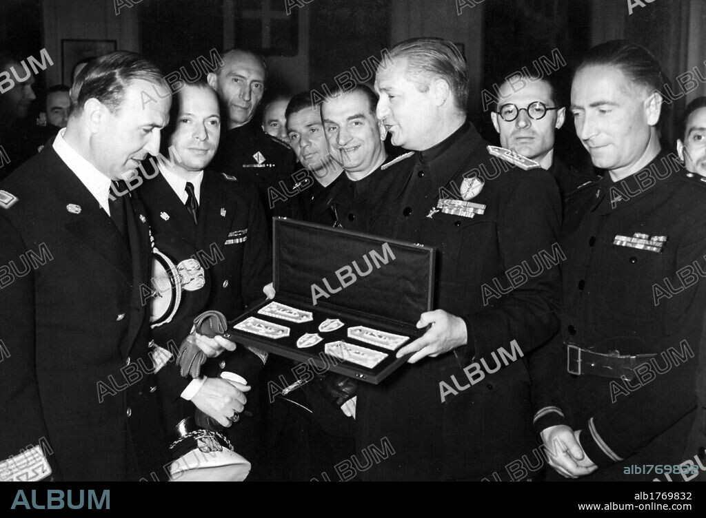 Paolo Ruggeri Laderchi and Dino Alfieri. Count Paolo Ruggeri Laderchi honouring Italian ambassador to Germay Dino Alfieri with the membership's emblems of the Grand Council of Fascism. Berlin, 14th June 1942.