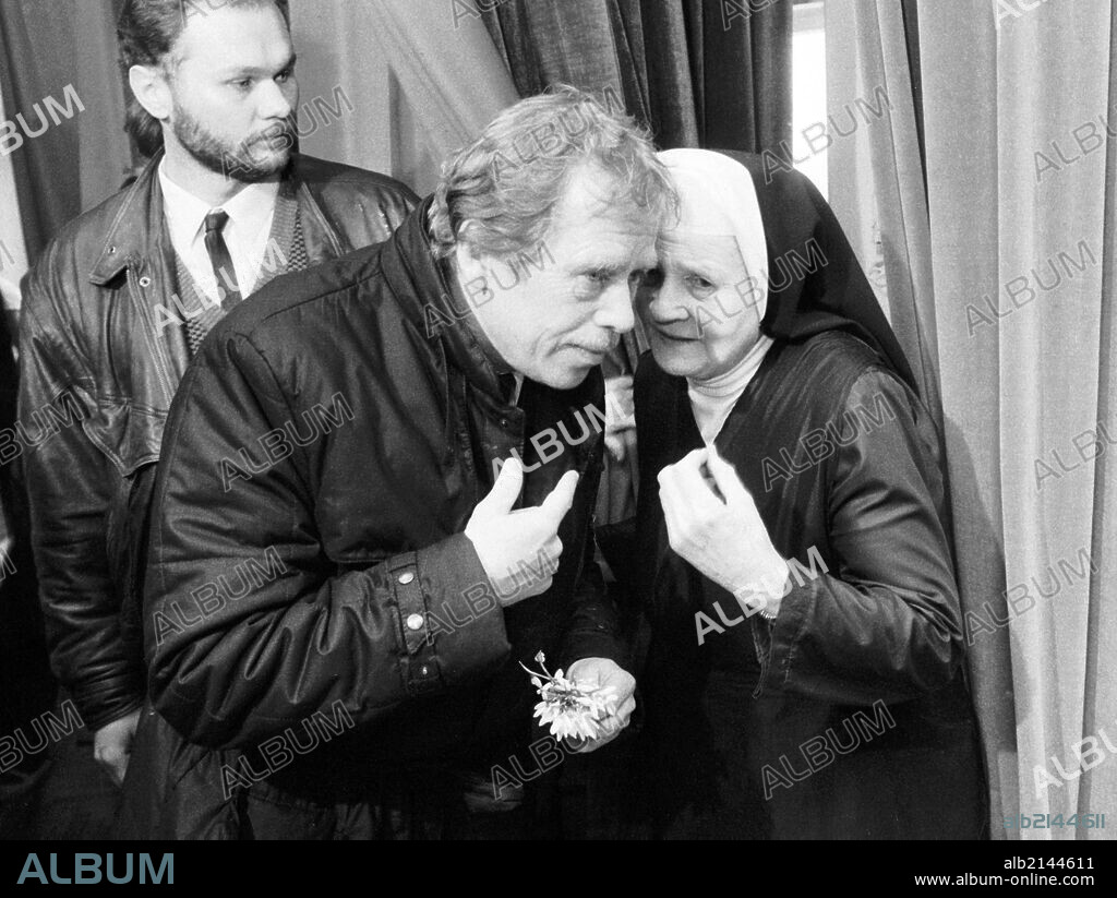 Czechoslovak President Vaclav Havel Listens To A Nun Nurse As He Visits Asylum For Mentally Handicapped In Mnichov On Mar11,1990. At Left Havel'S Bodyguard. On Feb 02 2003 Havel Will Leave His Office As The Longest Serving European Politician And The Last Active Politician From The Times Of Fall Of Communist Rule In Eastern Europe In 1989. Born In Prague In 1936, An Active Anti-Communist Playwright And Founder Of Charter 77 Dissident Movement, Whose Work Was Banned In His Home Country After 1968 Soviet Invasion To Czechoslovakia, Spent Altogether More Than Six Years In Prison On Several Occassions Between 1977 And 1989. After Getting Elected As Czechoslovak President In 1989, Havel Resigned To Protest Against The Split Of Czechoslovakia In 1992 Only To Be Elected Again As President Of The Independent Czech Republic. During Havel'S Term In The Office The Former Warsaw Pact Member Country Has Joined The Nato A Has Been Successfuly Negotiating Its Admission To The Eu.  (Photo by: Sovfoto/UIG via Getty Images).