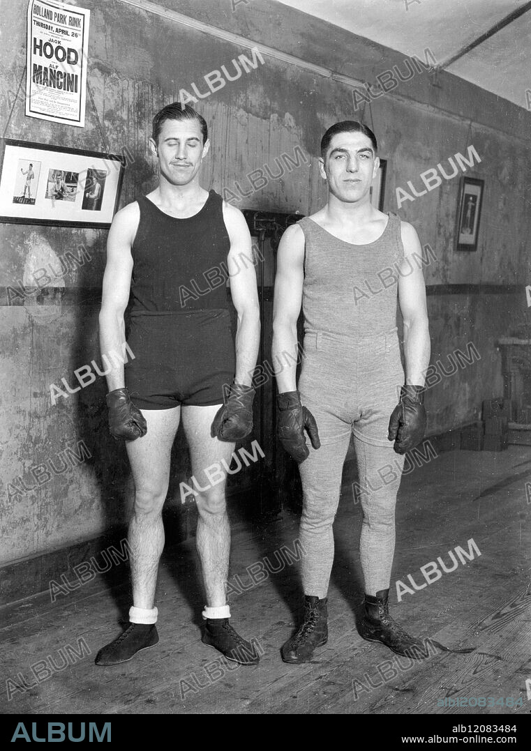 BOXING PEER IN TRAINING FOR FIGHT WITH POLICE-CONSTABLE. : Lord Knebworth, the 23 year old heir of the Earl of Lytton, who has already distinguished himself as a boxer of the welter-weight class, is in strict training for his four-round contest with Police Constable Bone of the Metropolitan Police at Ilford on April 2. He is training under Mr Alan Lambert with Alf Mancini, the professional boxer, as his sparring partner. Photo Shows: Lord Knebworth (left) with Alf Mancini at his training quarters. United Kingdom 1928.