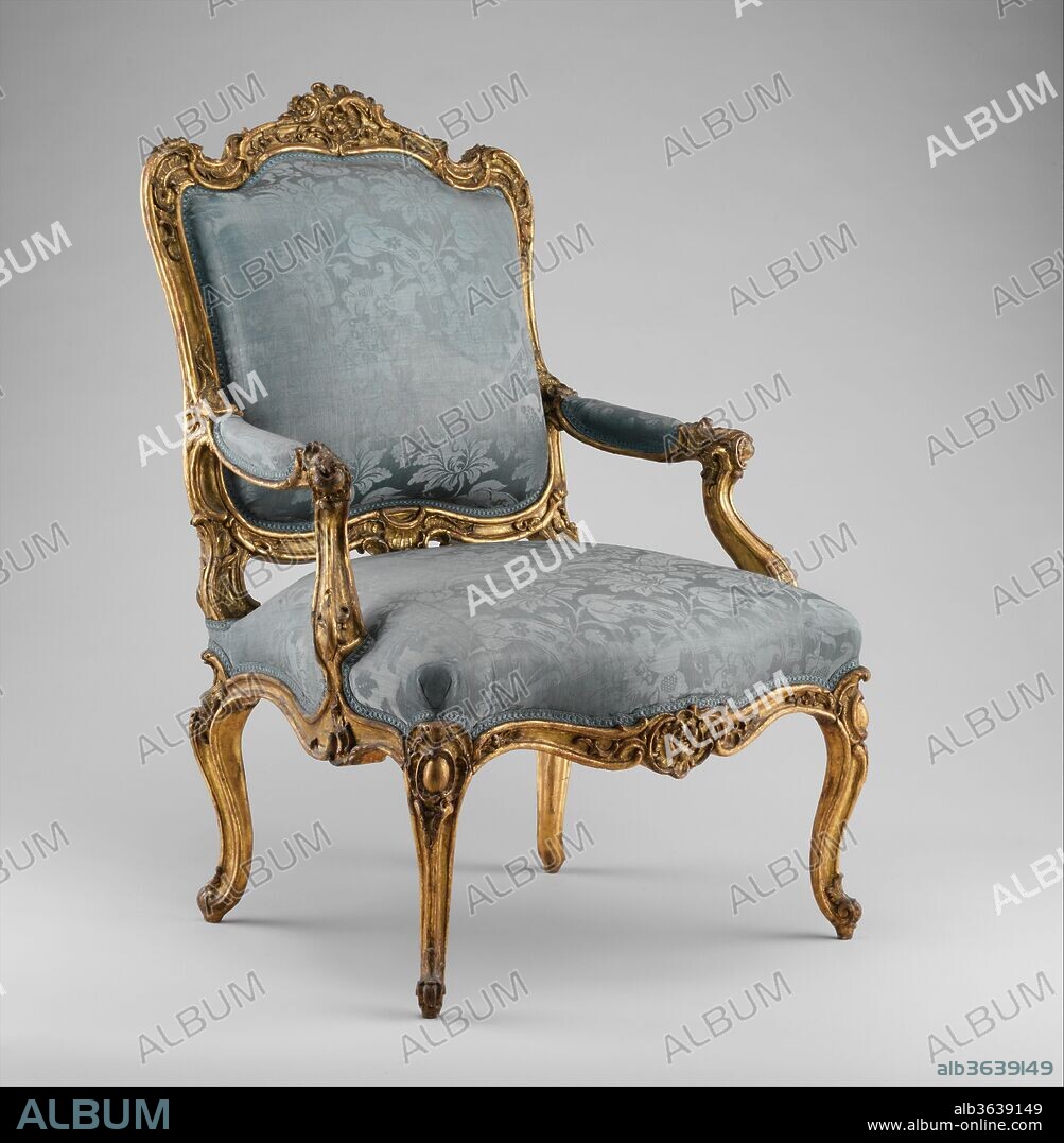 Armchair (fauteuil à la reine). Culture: Southwestern German. Dimensions: Overall: 43 1/4 × 29 1/2 × 23 1/2 in. (109.9 × 74.9 × 59.7 cm). Date: ca. 1750-60.
The flowing, curvilinear silhouette of this exuberantly carved armchair is close in inspiration to a design attributed to the French ornamentist and court goldsmith Juste-Aurèle Meissonier (1695-1750), who was named architect and designer to the king in 1726. Meissonier's chair is characterized by the same overall sweep of the back and cabochon-cartouches heading the legs, and a similar disposition of the armrests. As in the Museum's example, the crest and front rail are centered by an ornamental carving that retains a certain symmetry, although otherwise the Rococo ornament is full-blown.[1] An engraving by Meissonier published in Paris probably about 1735 resembles the drawing in many details and may have contributed to the popularization of the chair design abroad.
Thus, in its general form this German fauteuil à la reine is French, but the striking array of C-scrolls at the crest rail and the floral decoration on the central cartouche, as well as the expressive undulation of the side volutes in combination with the dramatic convex moldings of the armrest supports and scroll legs, have transformed the original Gallic conception into something much more dramatic, without compromising the French elegance or comfort.[2] In short, the composition of the frame elements has assumed a much greater importance in the German variation.[3] The gilding on the front, much of which is presumably original, catches the light, showing off the refinement of the carving. As a whole, the armchair strikes the eye as gracefully light and fancifully stylish, although it is difficult to estimate how the original upholstery and show covers might once have influenced this impression. (The blue eighteenth-century damask covers and the upholstery beneath it date from a conservation project undertaken at the Museum in 1963)[4]
The chair is part of a set, of which three other pieces are known. One was until 1995 in the collection of the grand dukes and margraves of Baden at the castle of Baden-Baden in Germany.[5] The other two entered the Museum in 1974 with the Lesley and Emma Sheafer Collection.[6] Mrs. Sheafer had acquired the pair in 1958 from the Munich art dealer Fischer-Böhler. By that time, they had already been stripped of their gilding or paint and had tapestry show covers. One of them is depicted in a painting by Fritz Bayerlein (1872-1955) of the Green Salon at Schloss Seehof, near Bamberg (see the label for acc. no. 1974.356.120),[7]  and a photograph thought to date shortly after 1900, taken in the south wing of Seehof, shows the same chair or its twin in situ.[8] Nonetheless, no archival evidence exists to prove that the armchairs were part of the well-documented eighteenth-century furnishings of the castle. Most probably, they were brought to Seehof during the nineteenth century.[9]
The set to which the present chair belongs may be compared with other South German seating furniture, such as the Audience Chair of the Elector of Bavaria at the Munich Residenz, dating to about 1750.[10] In 1958 Fischer-Böhler attributed the design of the pair that Mrs. Sheafer bought to the Franconian sculptor Ferdinand Tietz (1708-1777) and their manufacture to a workshop in Würzburg, but there is no written or circumstantial evidence for this. The strong French influence and the fact that one chair was formerly in the collection of the grand dukes and margraves of Baden suggest an origin for the set in southwestern Germany, possibly at a court workshop in Mainz, Bruchsal (see the catalogue entry for acc. no. 35.23.1, 2), Karlsruhe, the Palatinate, Württemberg, or the Baden-Baden region itself.[11]
[Wolfram Koeppe 2006]
Footnotes:
[1] Peter Fuhring. Juste-Aurèle Meissonnier: Un génie du Rococo, 1695-1750. 2 vols. Archives d'arts décoratifs. Turin and London, 1999, vol. 2, pp. 360-61, no. 95.
[2] For related French models, see Jules Mannheim and Édouard Rahir. Catalogue de la collection Rodolphe Kann: Objets d'art. Vol. 2, XVIIIe siècle. Paris, 1907, no. 195; and Charissa Bremer-David, with Peggy Fogelman, Peter Fusco, and Catherine Hess. Decorative Arts: An Illustrated Summary Catalogue of the Collections of the J. Paul Getty Museum. Rev. ed. Malibu, 1993, p. 64, no. 91.
[3] See Bruno Pons. "Arabesques, or New Grotesques." In The History of Decorative Arts: Classicism and the Baroque in Europe, ed. Alain Gruber, pp. 157-223. Trans. John Goodman, New York, 1996, p. 217.
[4] Archives of the Department of European Sculpture and Decorative Arts, Metropolitan Museum.
[5] Catalogue of the Markgrafen von Baden collection sale, Sotheby's, Baden-Baden, 5-21 October 1995, vol. 1, lot 106. That chair was described in the catalogue as nineteenth-century; however, one month before the sale, this author personally examined it and concluded that the frame was eighteenth-century, with some restoration and several layers of regilding. The chair was auctioned again, at Kunsthandel Hampel, Munich, in 2002.
[6] The accession numbers of this pair of chairs are 1974.356.199 and 1974.356.200.
[7] Illustrated in Adolf Feulner. Historic Interiors in Colour: Eighty Coloured Views from Castles and Private Houses. New York, 1929, pl. 45.
[8] York Langenstein and Michael Petzet. Seehof: Baugeschichte und Restaurierung von Schloss und Park. Bayerisches Landesamt für Denkmalpflege. Munich, 1985, p. 11.
[9] Gisela Masching[-Beck]. "Arrangements for th Margrave of Ansbach's Visit to Schloss Seehof, Whitsun, 1775." Furniture History 27 (1991), pp. 72, 80, n. 70, figs. 26-28.
[10] For the Electoral armchair, see Brigitte Langer, ed. Pracht und Zeremoniell: Die Möbel der Residenz München. Exh. cat., Residenz, Munich. Organized by the Bayerische Verwaltung der Staatlichen Schlösser, Gärten und Seen. Munich, 2002, p. 228, no. 72 (entry by Brigitte Langer). For other examples, see Heinrich Kreisel. Die Kunst des deutschen Möbels: Möbel und Vertäfelungen des deutschn Sprachraums von den Anfängen bis zum Jugendstil. Vol. 2, Spätbarock und Rokoko. 2nd ed. Rev. by Georg Himmelheber. Munich, 1983, figs. 460-65; and the catalogue of a sale at Christie's, Amsterdam, 11 December 2003, lot 214.
[11] Heinrich Kreisel. Die Kunst des deutschen Möbels: Möbel und Vertäfelungen des deutschn Sprachraums von den Anfängen bis zum Jugendstil. Vol. 2, Spätbarock und Rokoko. 2nd ed. Rev. by Georg Himmelheber. Munich, 1983, figs. 570, 580, 582 (these chairs have stylistically related, flowing, curvilinear ornament), 1058 (the movement of this clock is marked "Frankfurt," but the vividly designed case could have been carved in one of the court workshops mentioned).