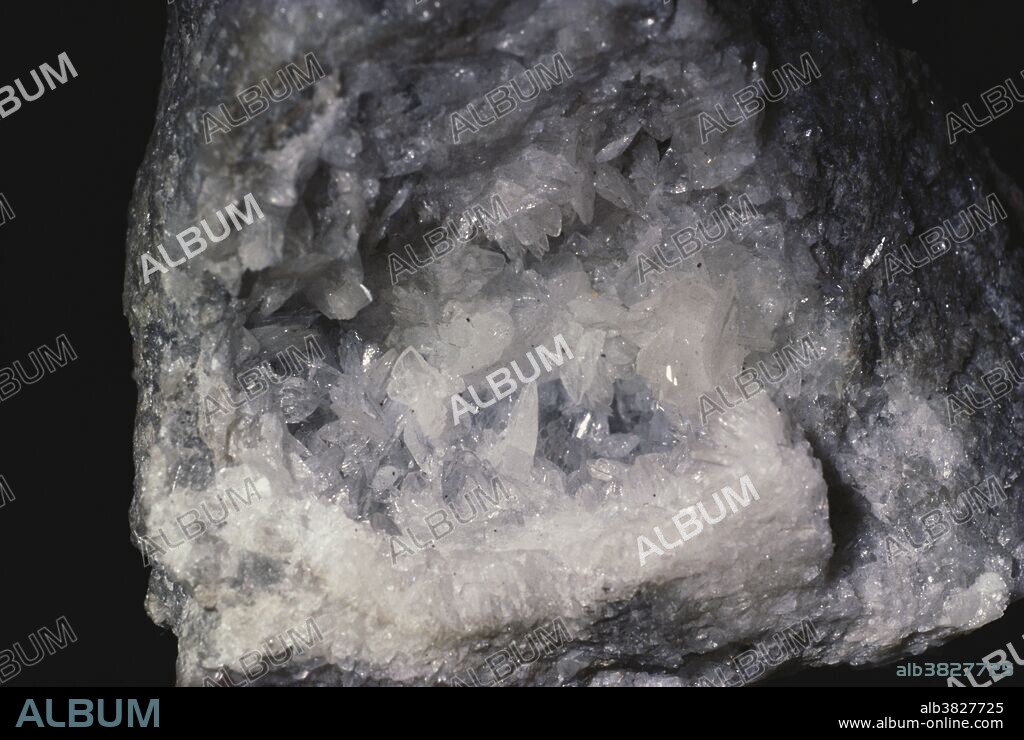 Crystals of colemanite, a calcium borate mineral used as an ore of boron.  Colemanite forms from the alteration of borax in playa lakes and other evaporite deposits.