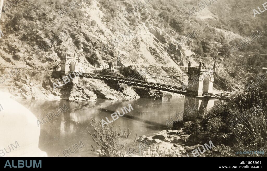 India, View of Victoria Bridge over the Beas River at Mandi. The suspension bridge was built by Raja Bijai Sen and the colonial British government in 1877. Original manuscript caption: MANDI BRIDGE, 1920. 2001/243/1/1/3/33.