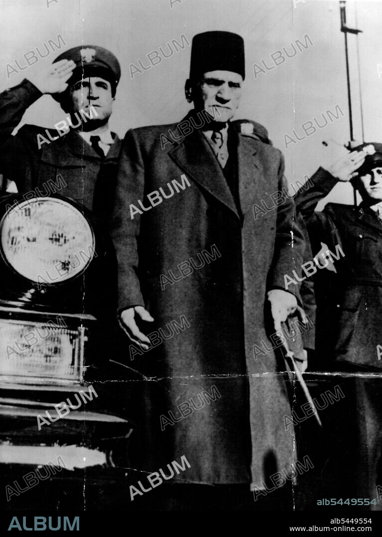 Syria's new President, Hashem Attassi, stands to attention while the band plays the National Anthem at a ceremony in Damascus, marking the new regime. March 13, 1954. (Photo by The Associated Press Ltd.).